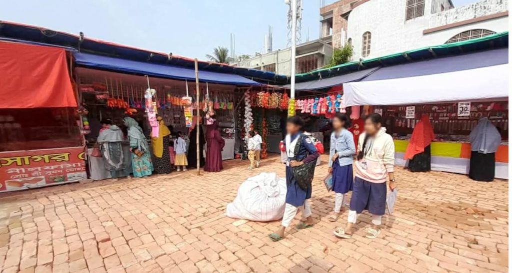 A trade fair is going on in the Naogaon High School grounds, but the administration and president are unaware.